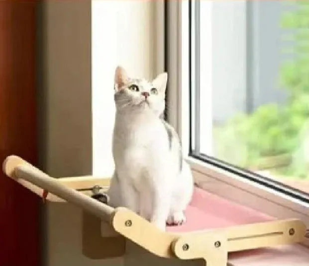 Hamac radiateur pour chat rose suspendu avec un chat dessus