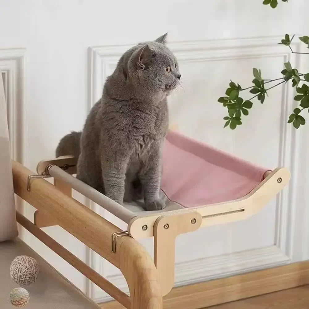 Hamac pour radiateur pour chat rose avec un chat dessus